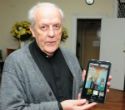 Image of Josu Iriondo, the pastor of Saint Anthony of Padua Roman Catholic Church, with a picture of the stolen crucifix.
