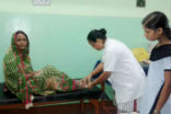 Image of Sr. Philomena Guria RNDM treating a snake bite patient