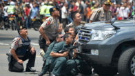 Image of Indonesian police take cover during the ISIS attacks in Jakarta.