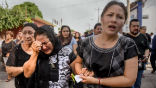 Image of Women mourn as workers search for survivors of the 8.1 quake that struck Mexico in early September. 